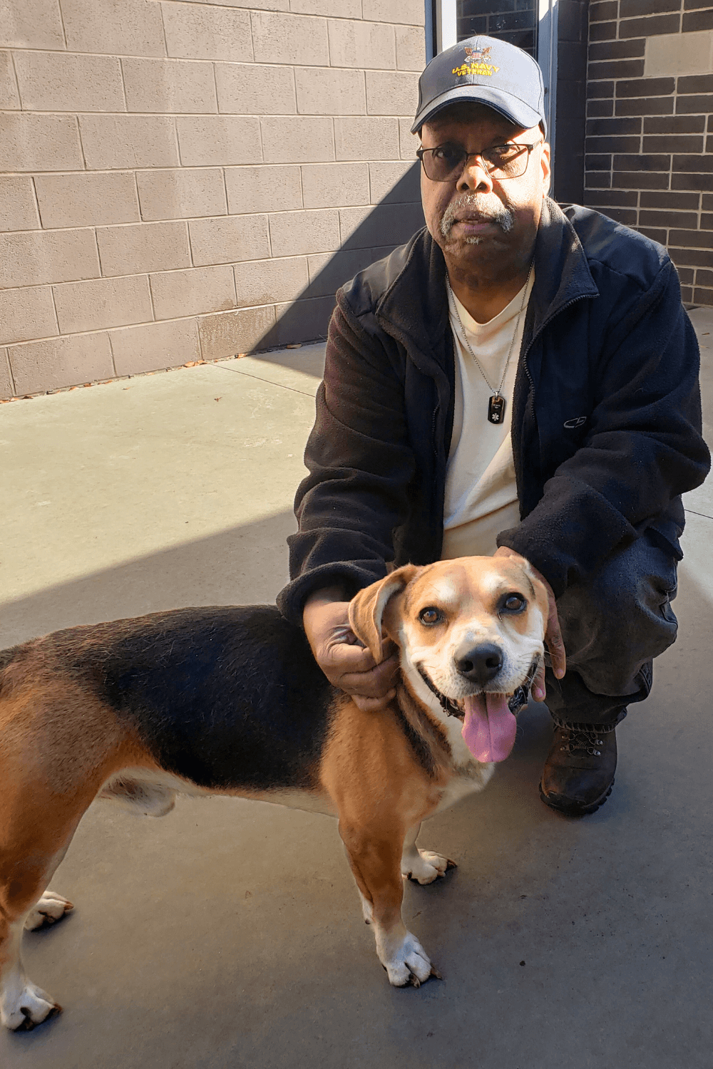 Abandoned dog now a Navy veteran's football watching friend